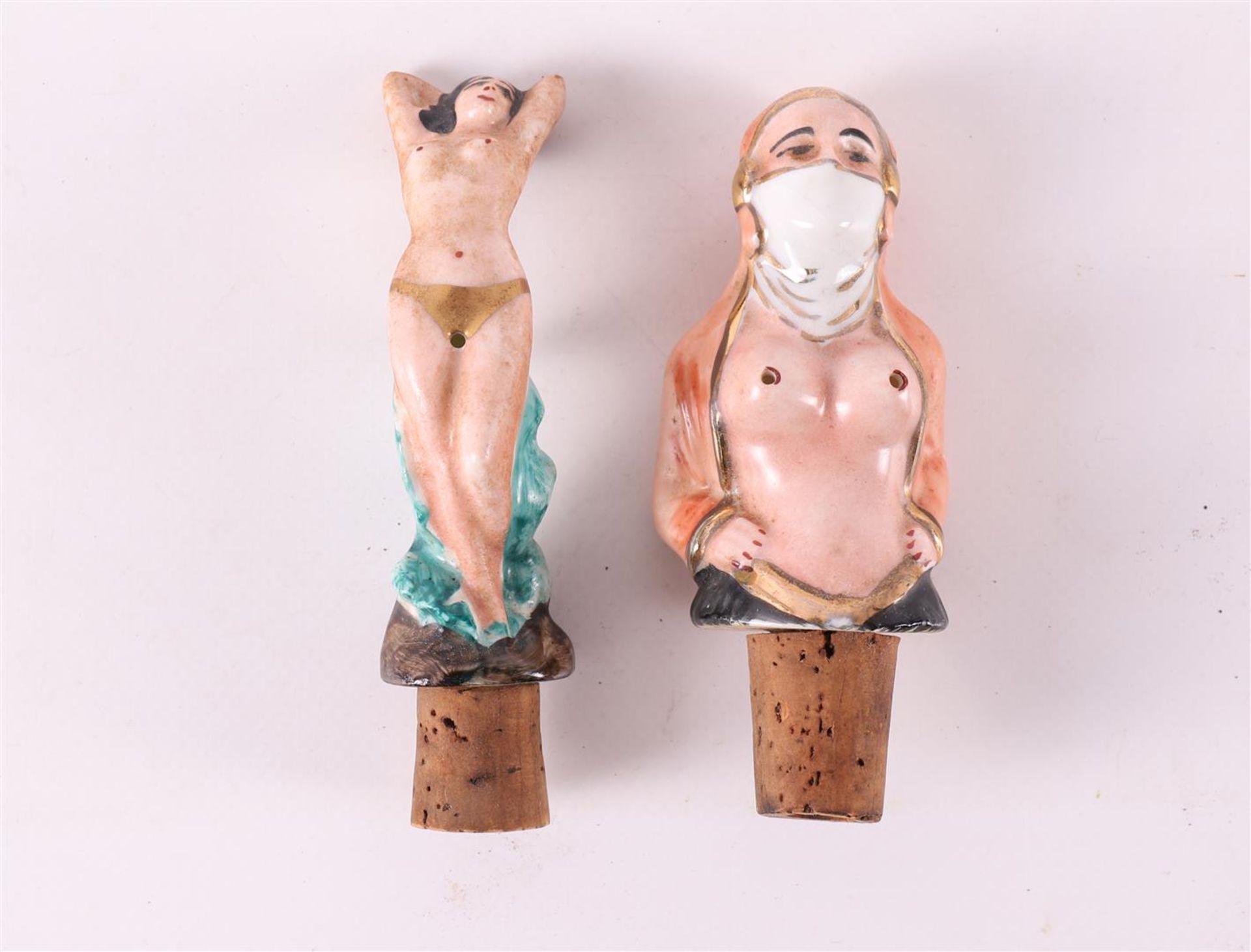 Two various decorative porcelain corks of erotic female nudes, ca. 1930.