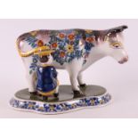 A polychrome earthenware cow with milker, Makkum, Tichelaar, mid 20th century.