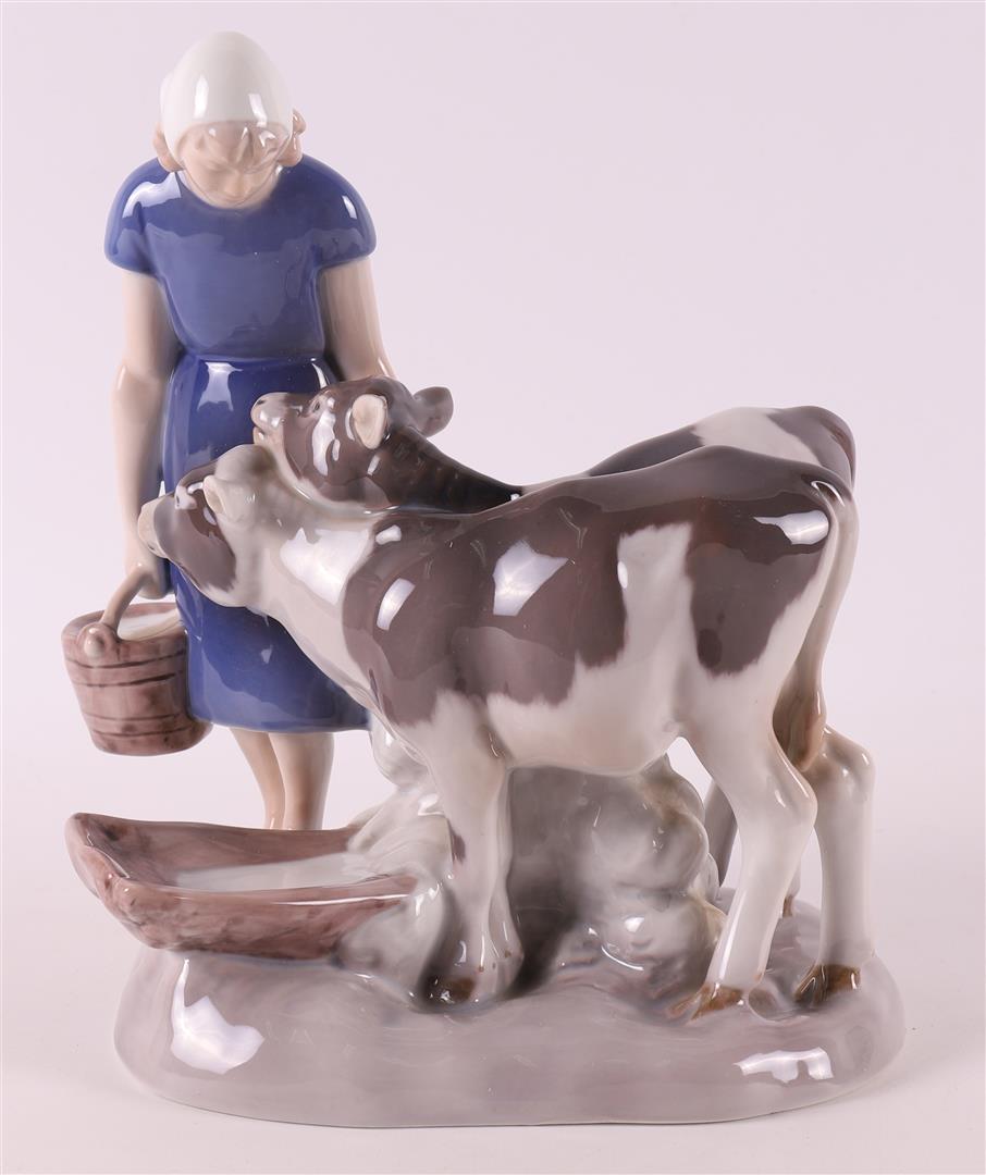 A polychrome porcelain girl with two calves, Denmark, Royal Copenhagen
