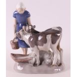 A polychrome porcelain girl with two calves, Denmark, Royal Copenhagen