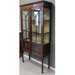 A two-door display cabinet, England, circa 1900.