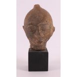 A terracotta head on wooden base, possibly 18th century or earlier.