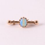 A 14 carat 585/1000 yellow gold bar brooch with cabochon cut opal.