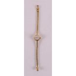 A women's wristwatch in a 14 kt gold case and ditto gold strap, marked: Restatio