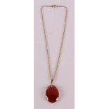 A 14 kt gold necklace with carnelian pendant in gold frame, 20th century