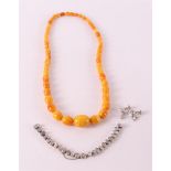 A necklace of ascending oval honey amber.