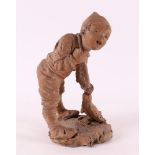 A terracotta sculpture of a boy with broom, Italy 19th century.