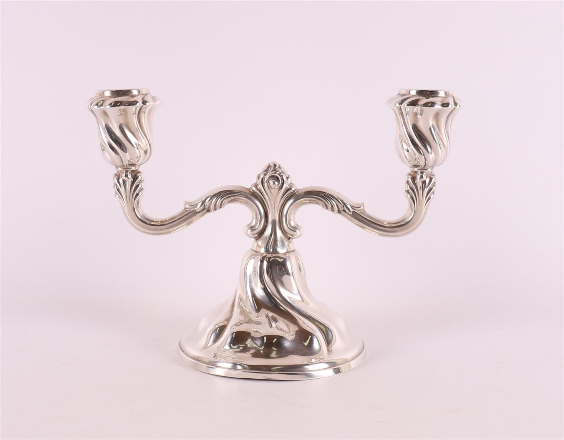 A set of 2nd grade 835/1000 silver two-light candlesticks.