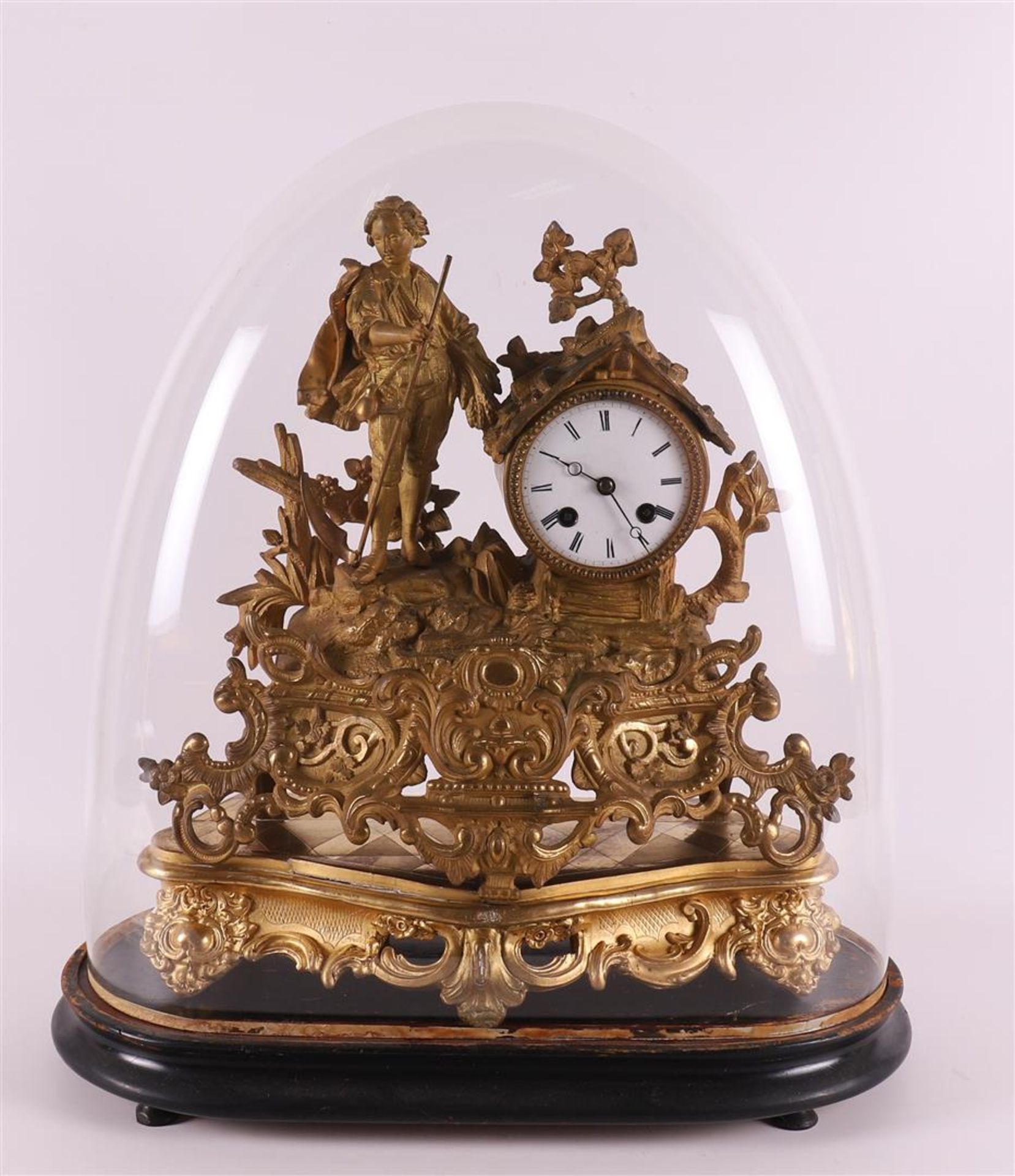 A gilded white metal mantel clock under glass dome France 19th century.