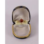 A 14 kt 585 yellow gold ring, set with diamond-cut red sapphire.