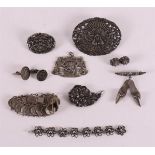 A lot of various silver, including brooches and dime bracelet.