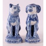 A blue and white earthenware seated dog and cat, Makkum, Tichelaar, 20th century