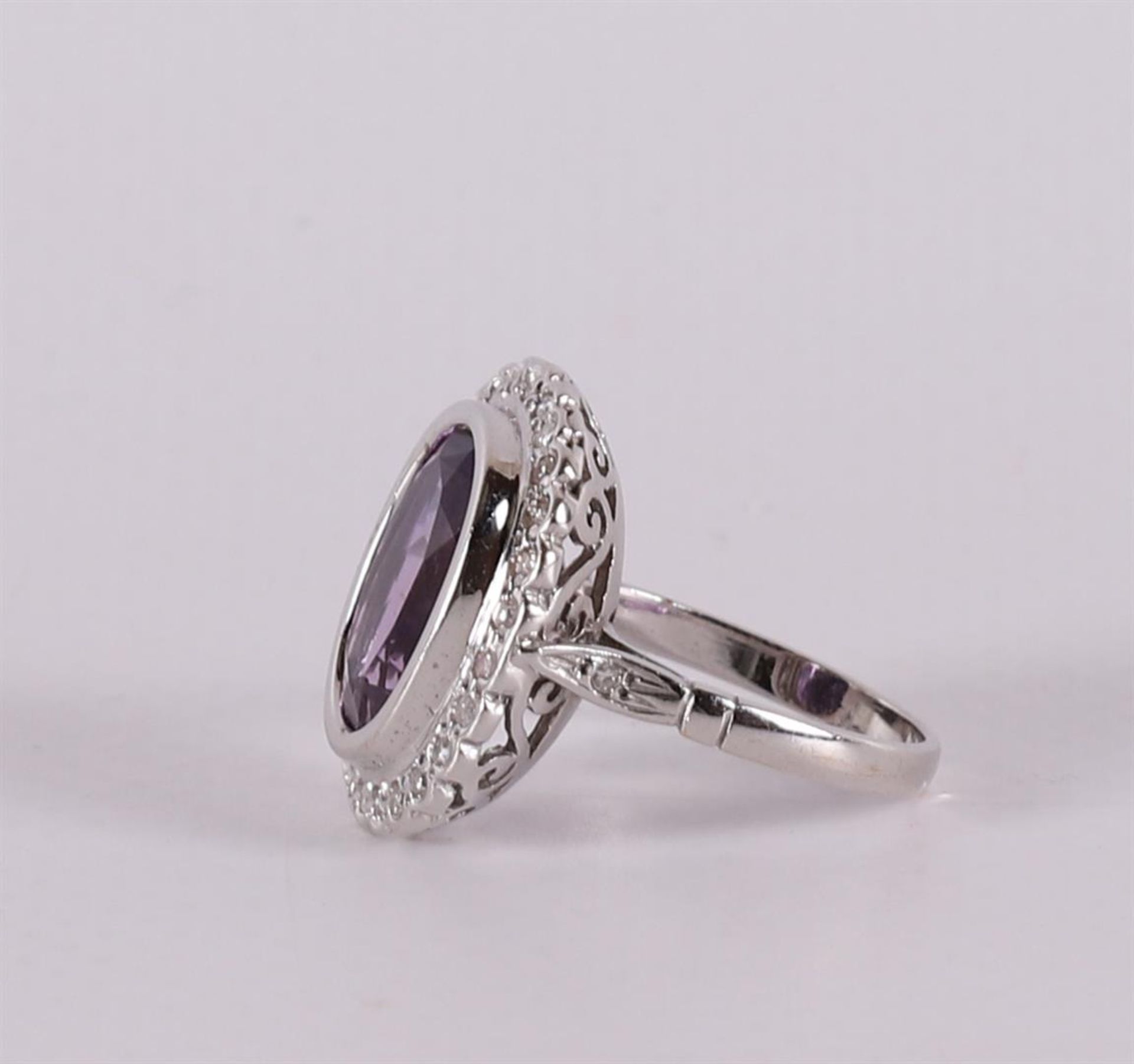 An 18 carat gold ring with an oval faceted amethyst and diamonds. - Image 2 of 2