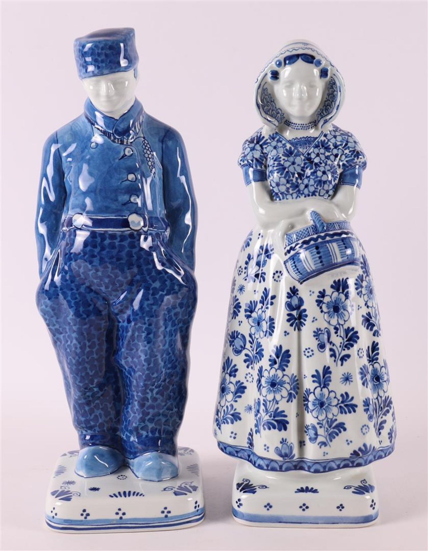 An earthenware farmer and farmer's wife in traditional costume, De Porceleyne Fl