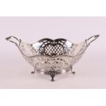 A pierced 2nd grade silver choux basket with handles and pearl rim.