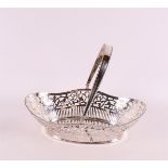 A pierced second grade silver bread basket with handle and pearl rim