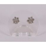 A pair of 14 carat gold stud earrings with 14 diamonds.