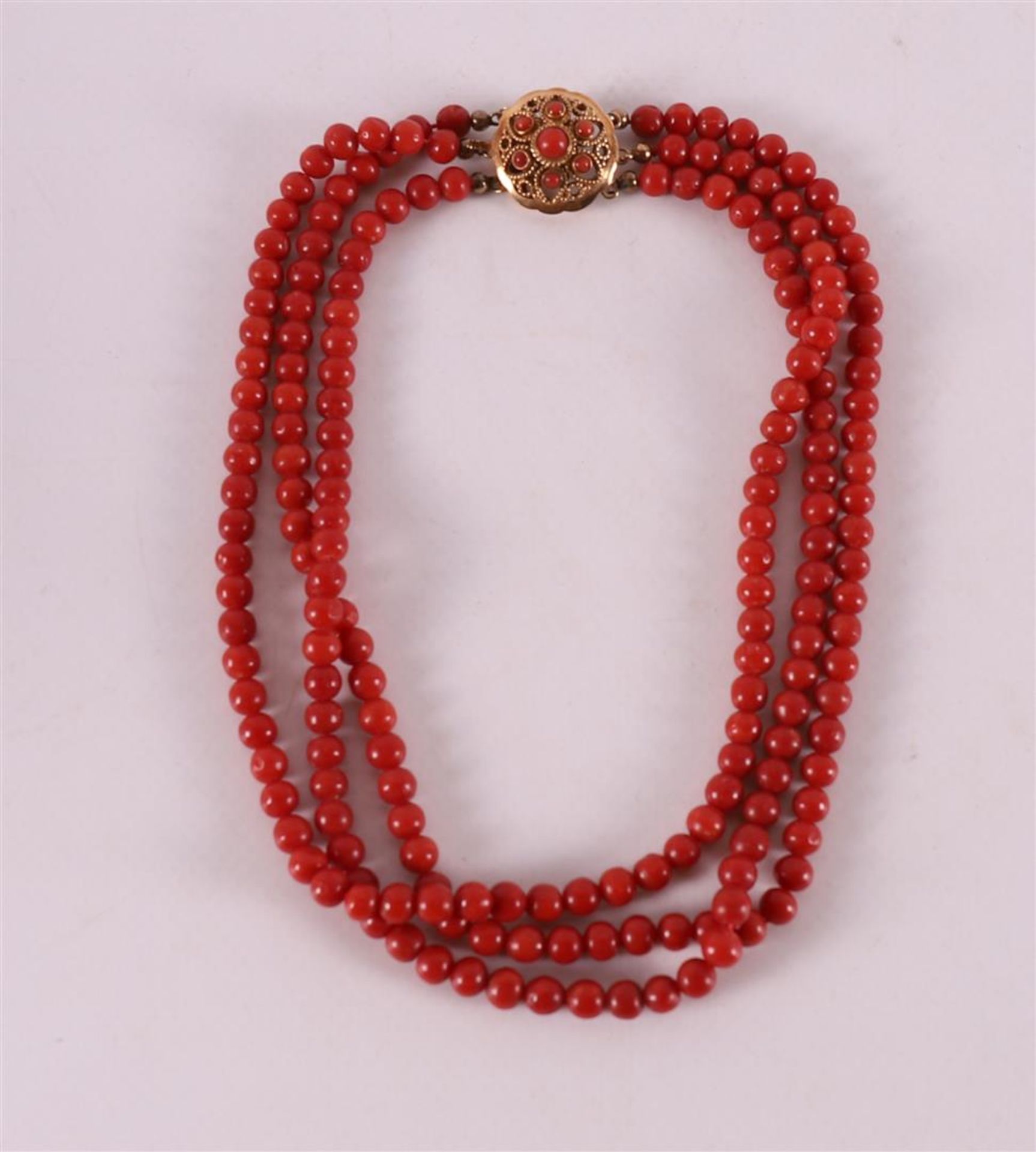 A three-row necklace of precious corals with a round filigree gold clasp, ca. 19