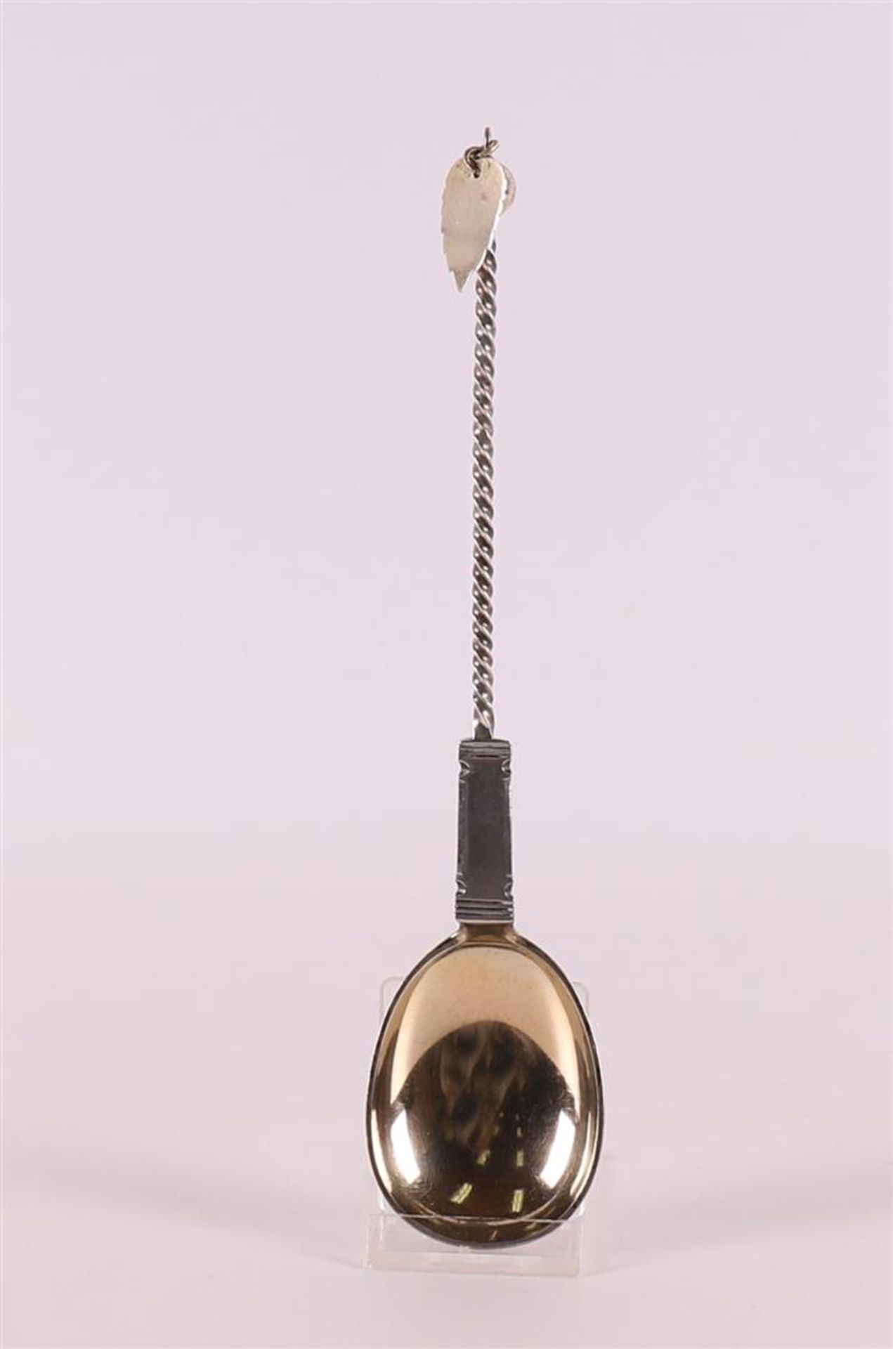 A second grade silver spoon with gilded bowl, twisted handle ending in leaf