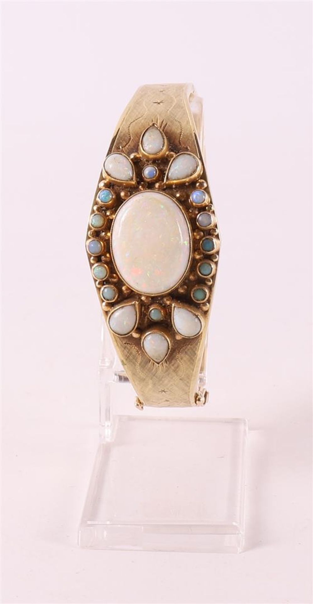 A 14 carat 585/1000 yellow gold rigid bracelet with opal and colored stones.