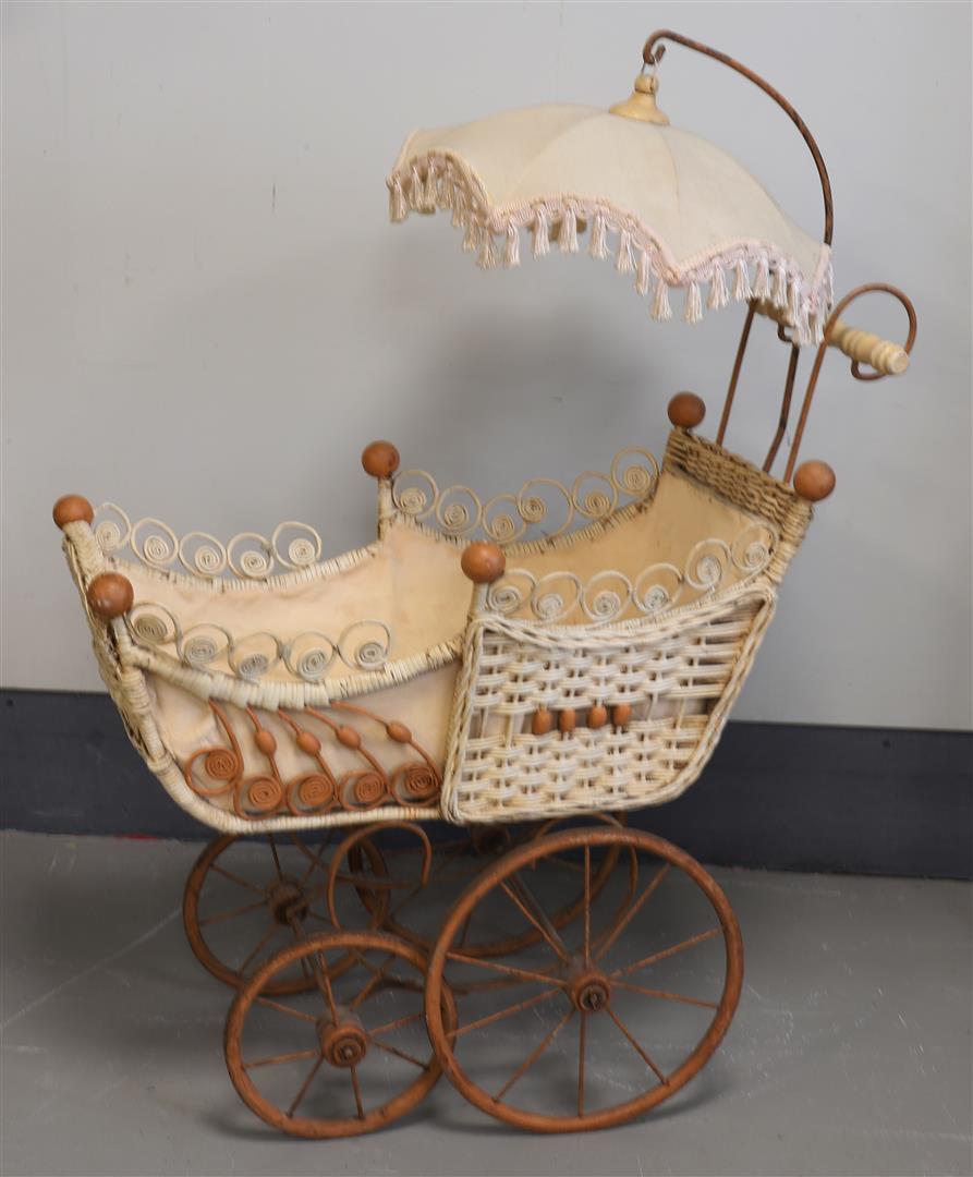 A rattan doll's pram with parasol, 19th century.