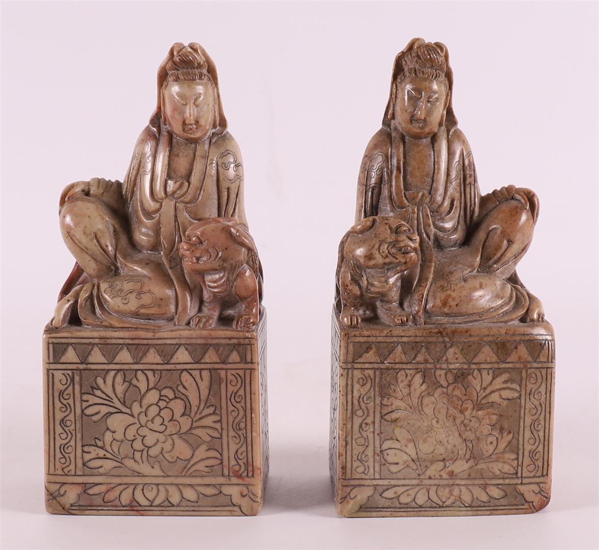 A set of soapstone supports in the shape of a seated Long Lijs and a dog of Foo