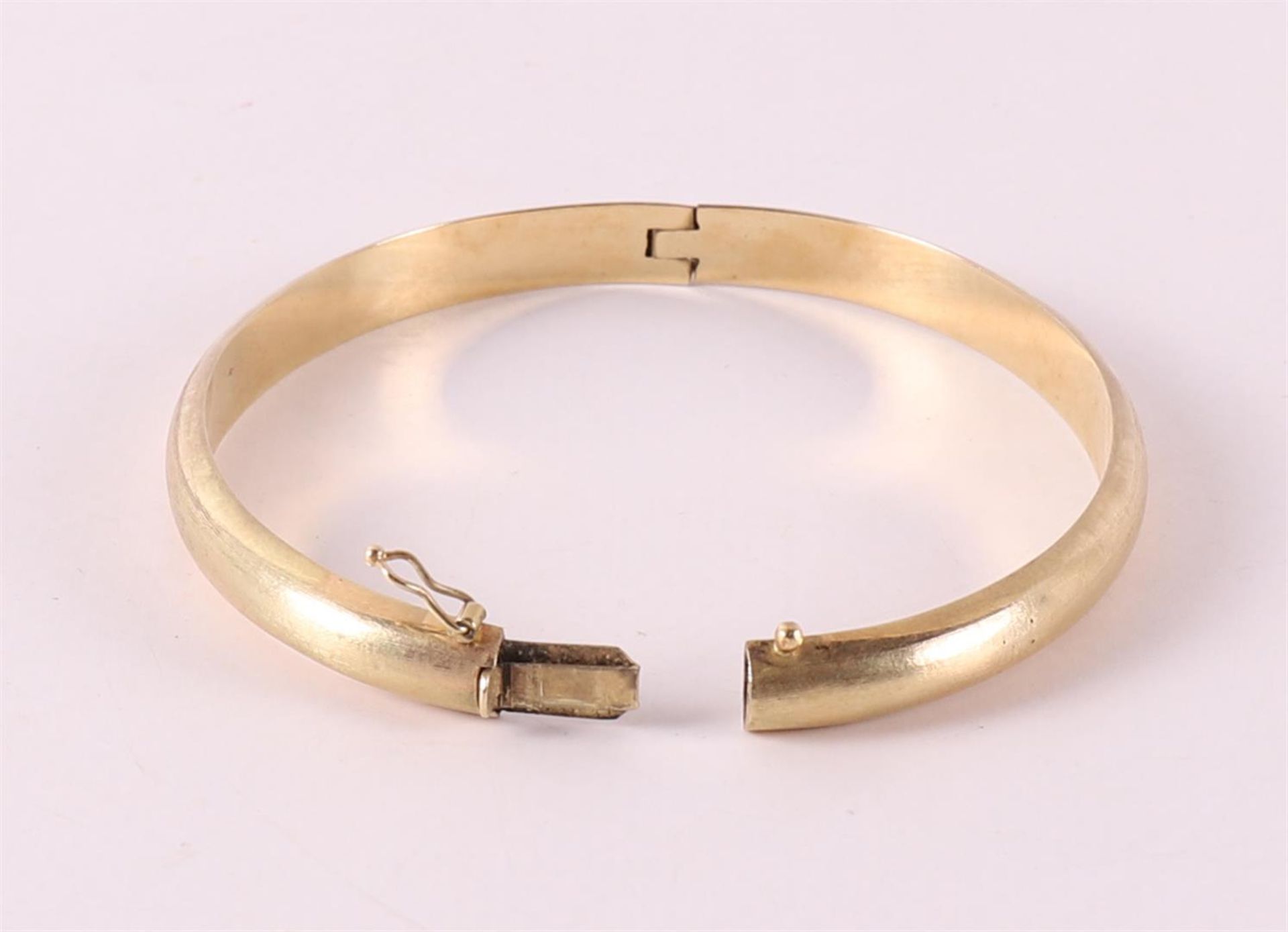 A 14 kt 585/1000 yellow gold slave bracelet. - Image 2 of 2