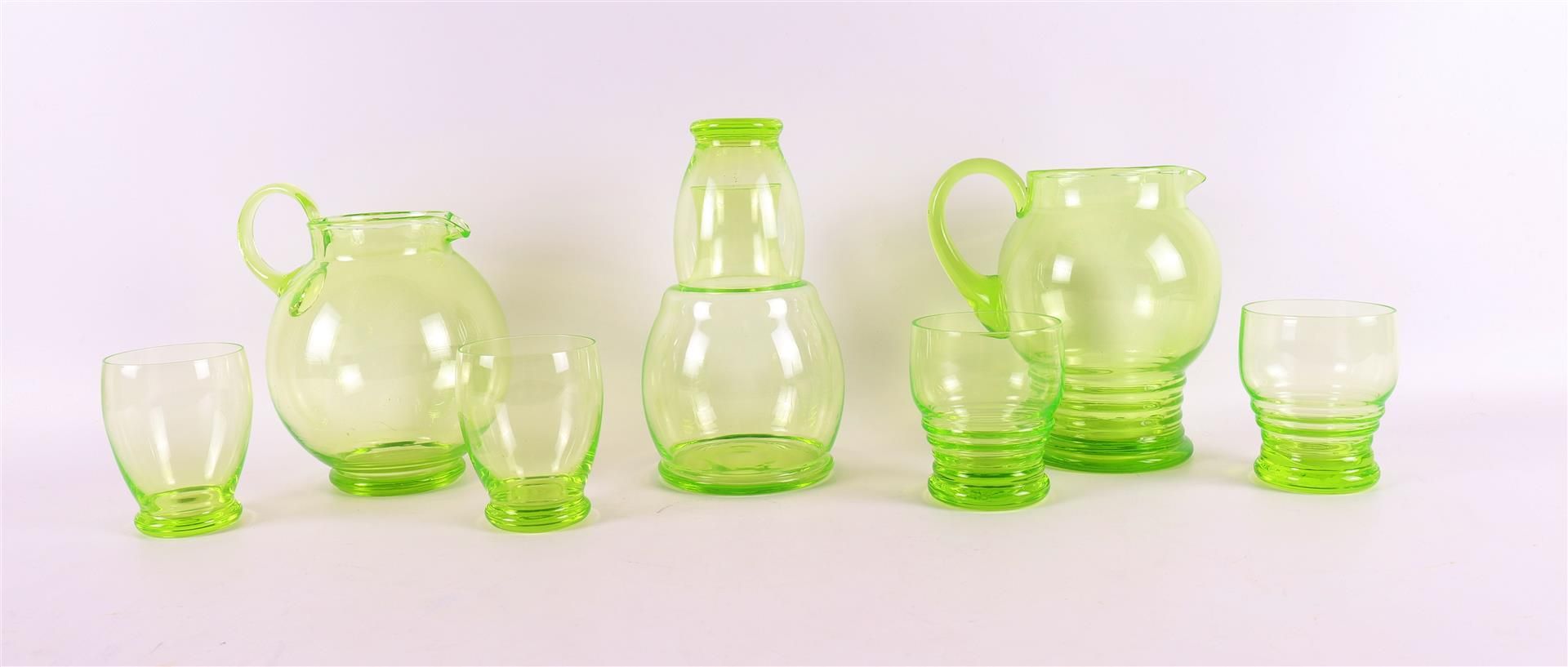 An Anna green glass water carafe 'Helios' with glass, design: W.J.Rozendaal 1933