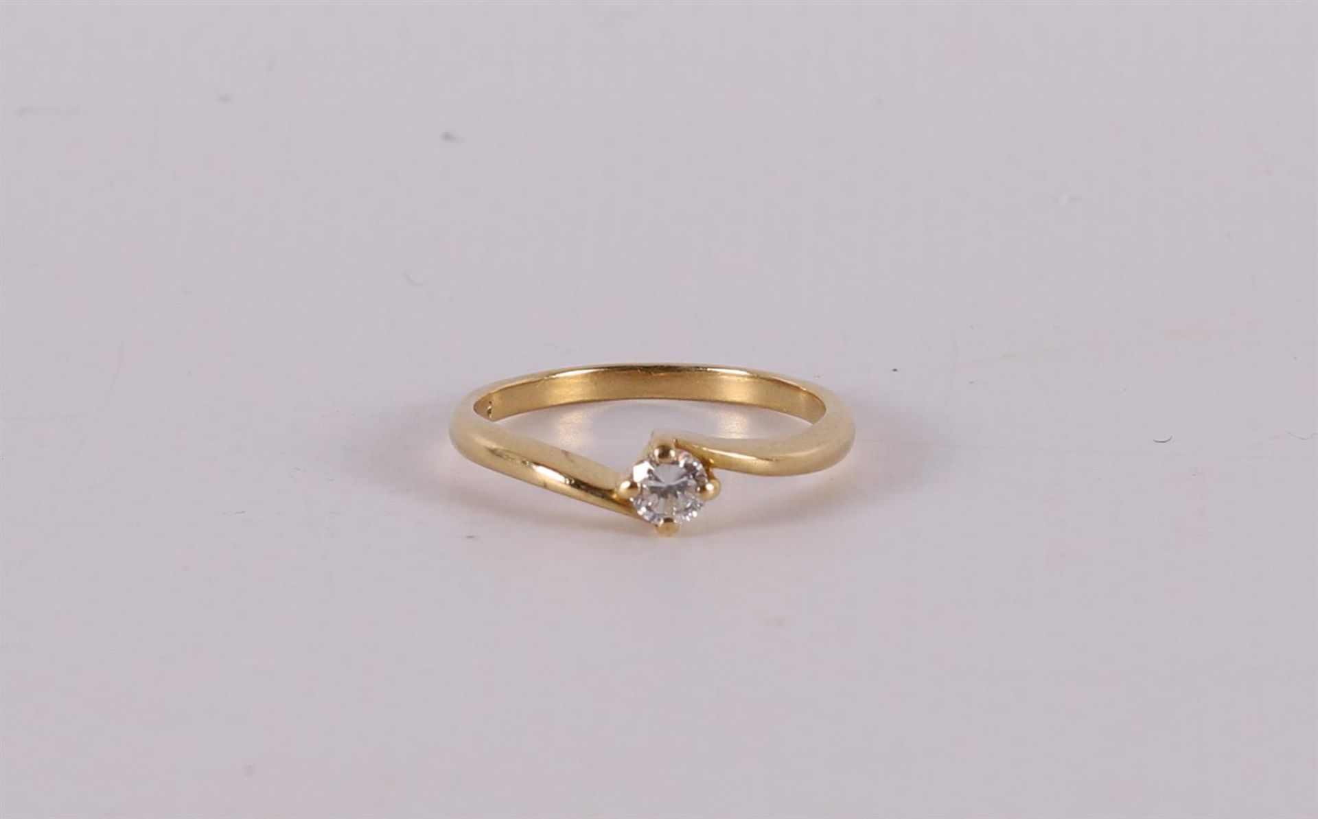 An 18 carat gold solitaire ring with a brilliant.