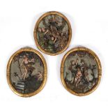 A set of three German or Austrian carved giltwood and polychrome painted oval relief panels