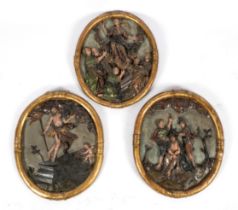A set of three German or Austrian carved giltwood and polychrome painted oval relief panels
