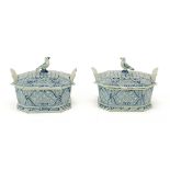 A pair of Dutch Delft blue and white butter dishes with bird finials