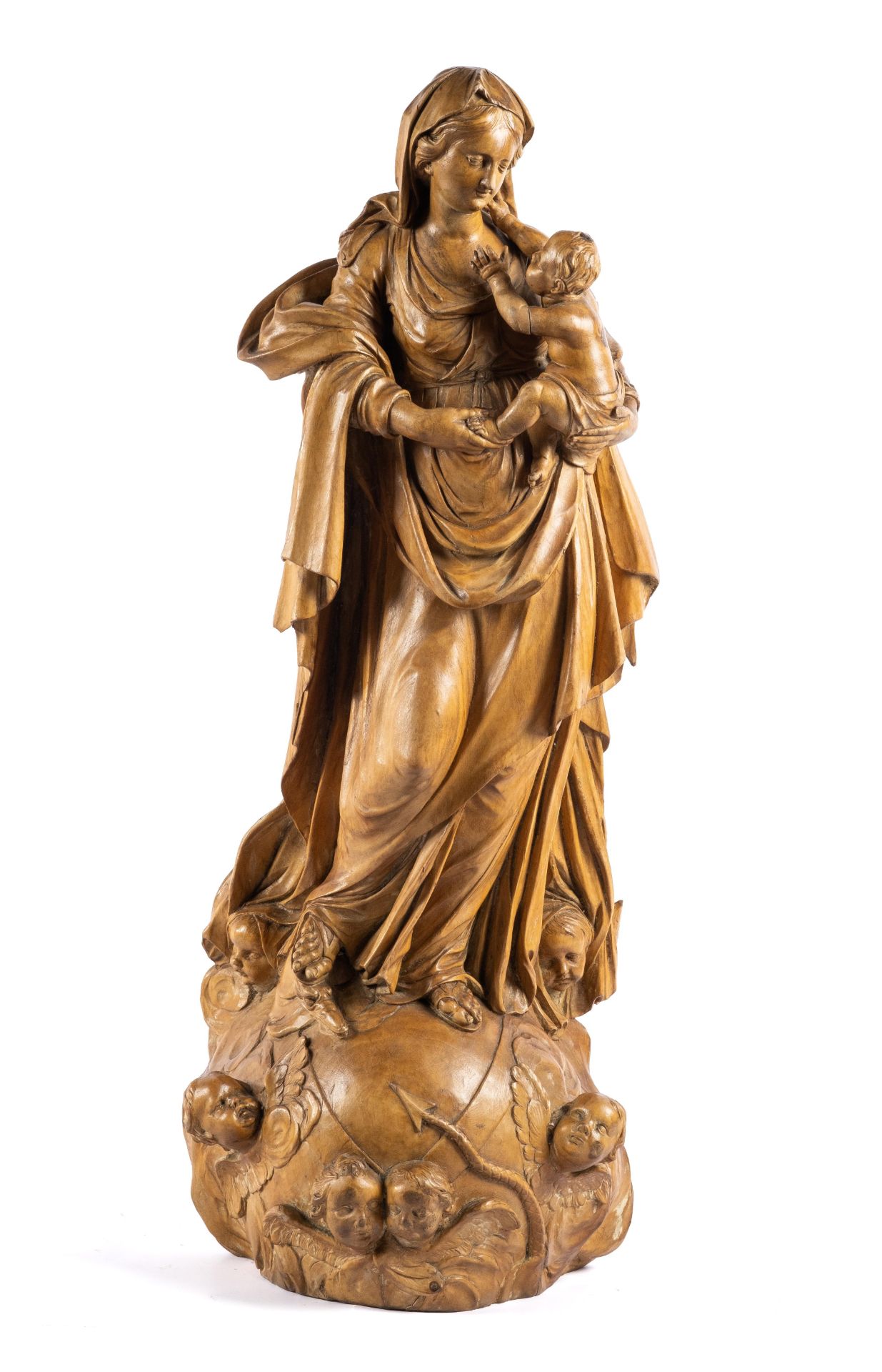 A Flemish carved limewood figure of the Virgin and Child atop the Globe