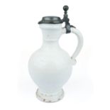 A Delft white pottery pitcher with pewter lid