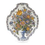 A large Delft polychrome pottery floral wall plaque