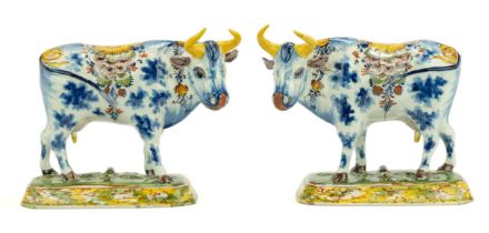 A pair of Delft polychrome pottery cows