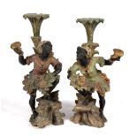 A pair of carved and polychrome painted figural pedestals