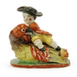 A Dutch Delft polychrome dish as a boy on a bird