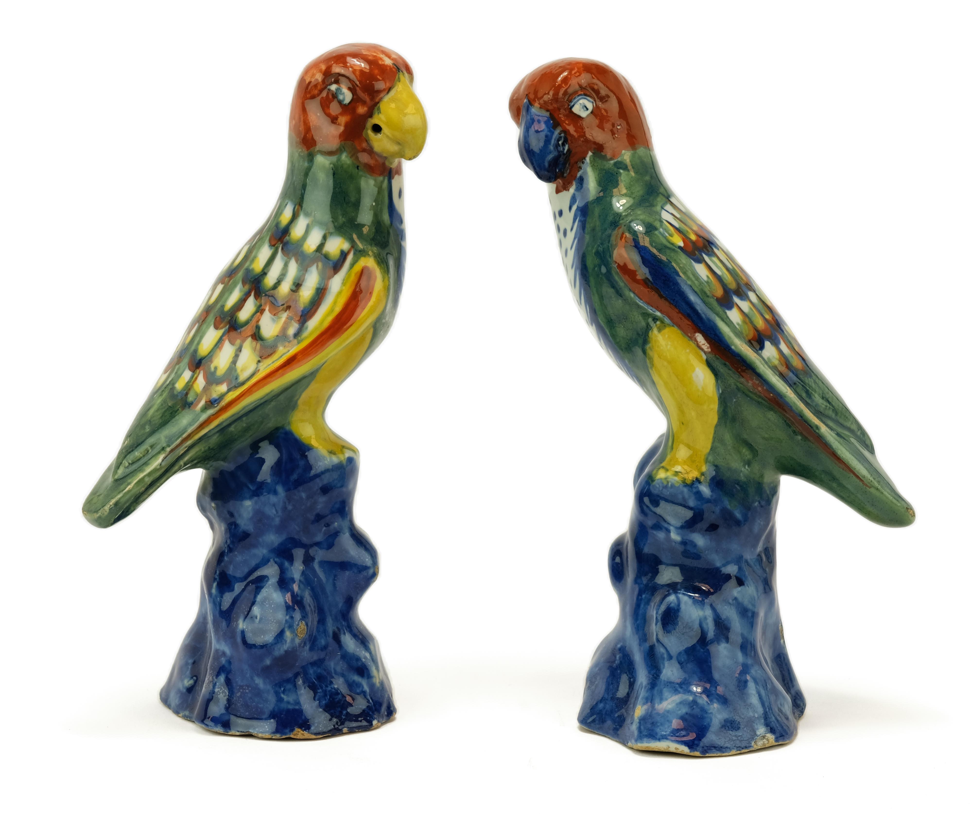 A pair of Dutch polychrome Delft pottery parrot figures