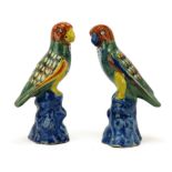 A pair of Dutch polychrome Delft pottery parrot figures