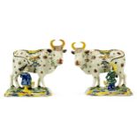 A pair of Dutch polychrome Delft pottery cow milkers