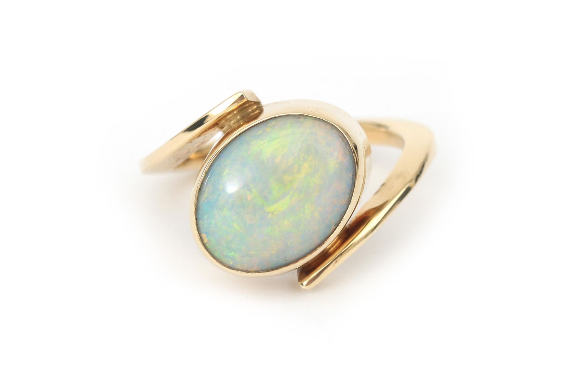 A 14 karat gold cross over opal ring 