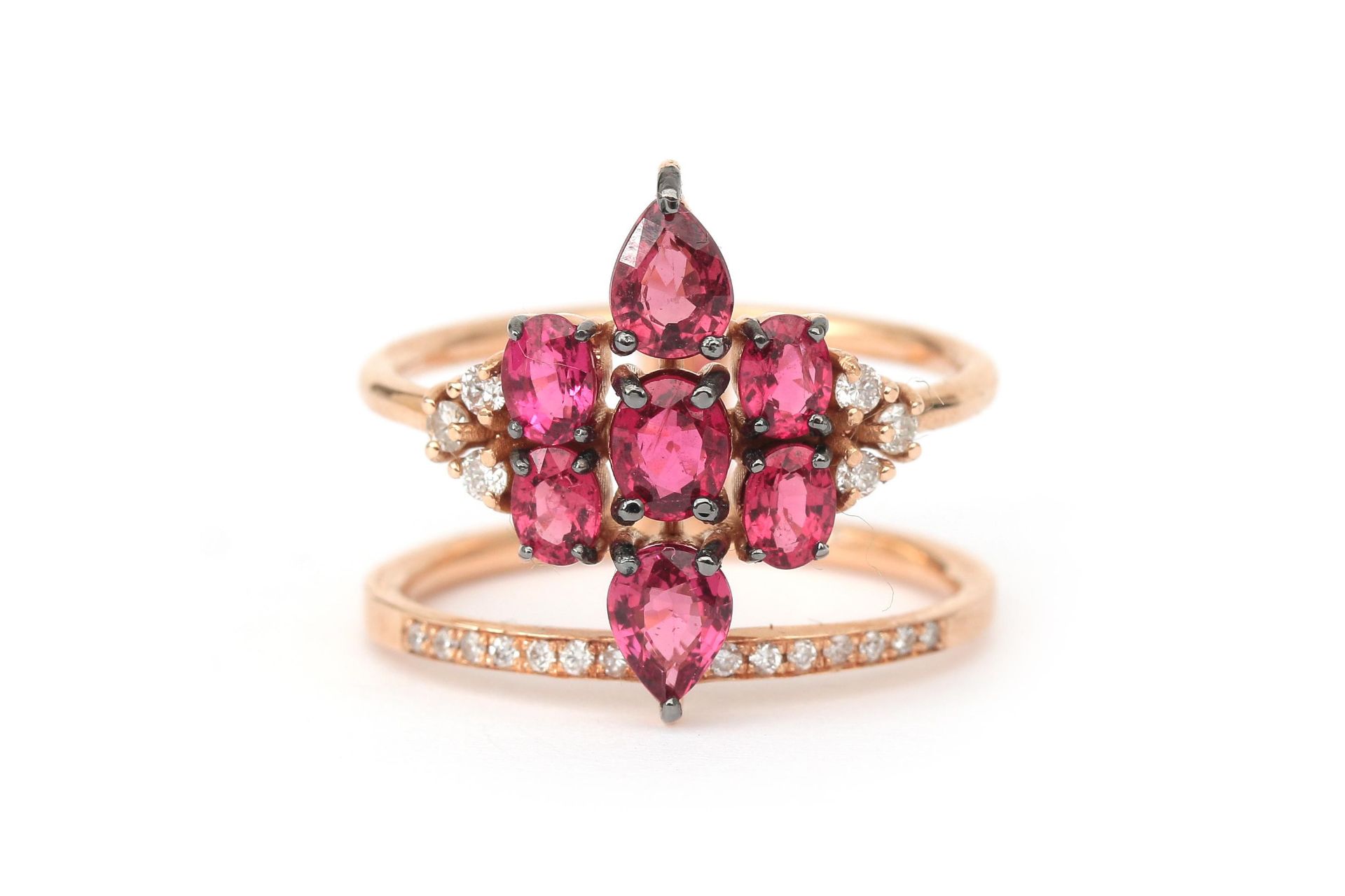 An 18 karat rose gold star shaped ruby and diamond cluster ring 