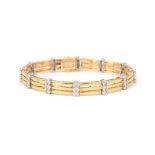 An 18 karat gold two tone diamond link bracelet