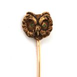 An 14 karat gold pin in the shape of an owl