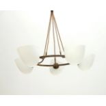 Midcentury Modern A brass hanging lamp with five frosted opaline glass shades, circa 1960. 75 cm.