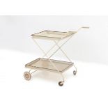 Mathieu Mategot (1910-2001), in the style of A white lacquered pierced metal trolley with brass