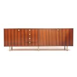 Alfred Hendrickx (1931) A rosewood veneered sideboard with three cupboard doors and four drawers,