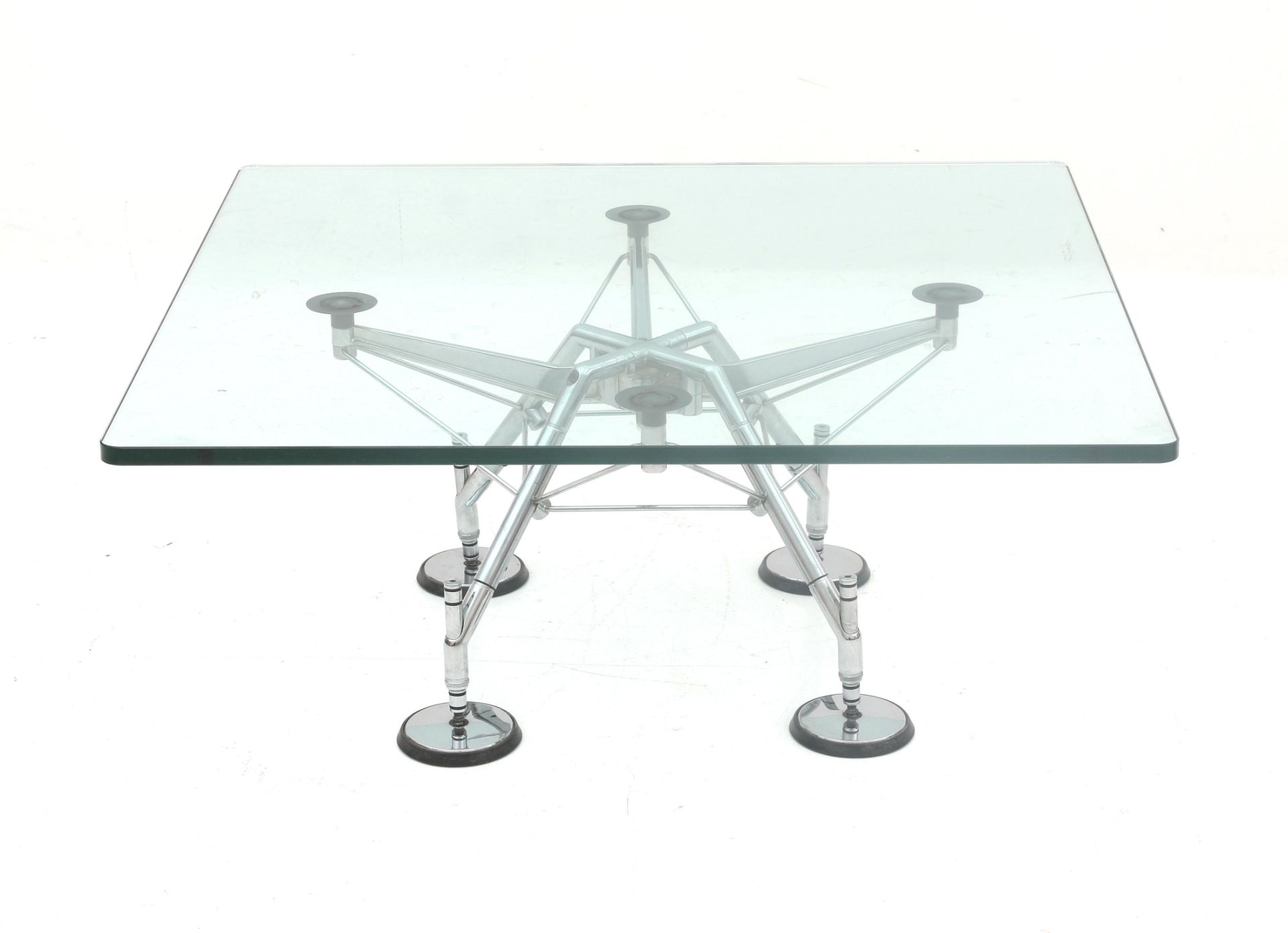 Norman Foster (1935) A chromium plated metal coffee table with square section glass top, from the