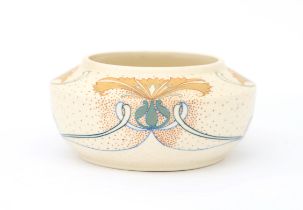 N.V. Arnhemsche Fayencefabriek A matt white glazed ceramic bowl with stylised linear and floral